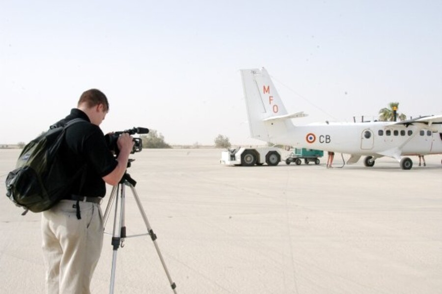 Kane Farabaugh filming a peacekeeping mission aircraft